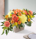 Autumn Harvest Centerpiece with orange and yellow seasonal flowers